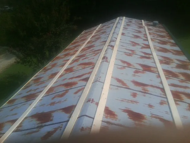 Rusted metal roof panels with new wood purlins before replacement — Storm Damage Roof Repair in Middle Point by Roofing Brothers